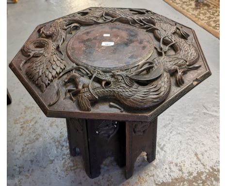 Chinese carved hardwood octagonal folding lamp table, overall decorated with dragons. (B.P. 21% + VAT)Rough condition overall