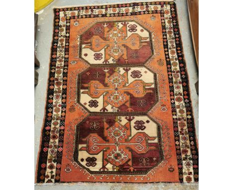 Terracotta ground Persian medallion design rug, with three central panels of repeating design. 120x165cm approx. (B.P. 21% + 