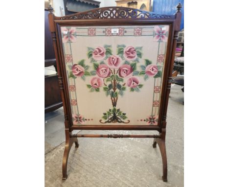 Edwardian mahogany framed fire screen, the needlepoint panel decorated with roses and foliage.  (B.P. 21% + VAT)