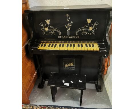 'Hering' Stradivarius, a miniature ebonised child's piano and stool.  (B.P. 21% + VAT)