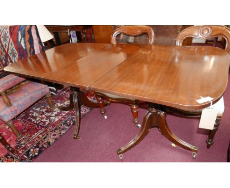 A late 19th century mahogany dining table raised on twin pillar supports with three splayed legs and castors and extra leaf, 