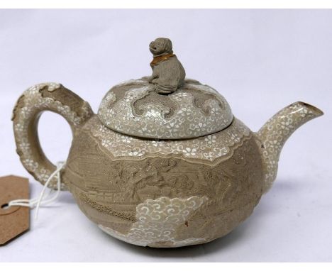 A small 19th century Japanese ceramic teapot, second half 19th century, glazed in part with white floral pattern, relief deco