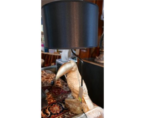 A contemporary table lamp, with a gilt a gilt composite toucan base and black drum shade, H.71cm 