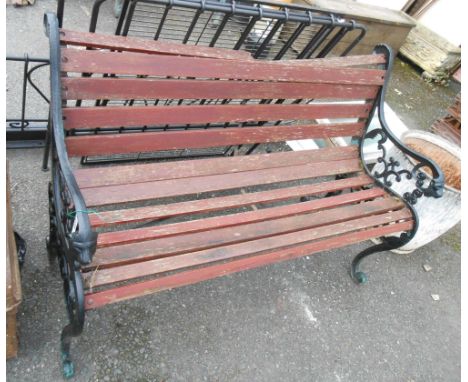 A 20th Century garden bench with cast iron ends and slatted wood seat