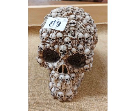A cast resin skull with composite bone and skull decoration