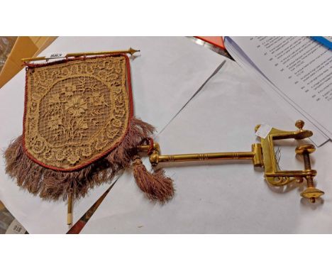 A Victorian folding face screen with brass clamp and bracket and lacework hanging panel screen