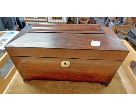 A 19th Century rosewood veneered sarcophagus tea caddy with fitted interior containing two tea canisters and an associated gl