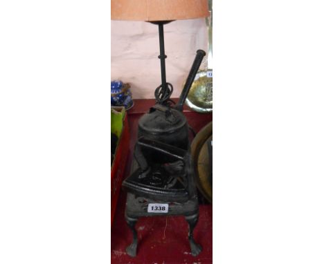 A 19th Century Baldwin small cast iron saucepan and lid, a cast iron trivet, flat iron and wrought iron lamp