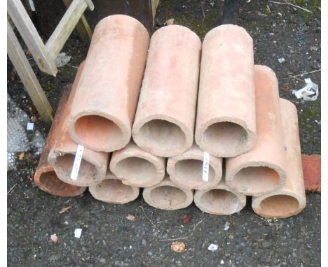 Twelve terracotta drainage pipe sections - for wine bottle storage