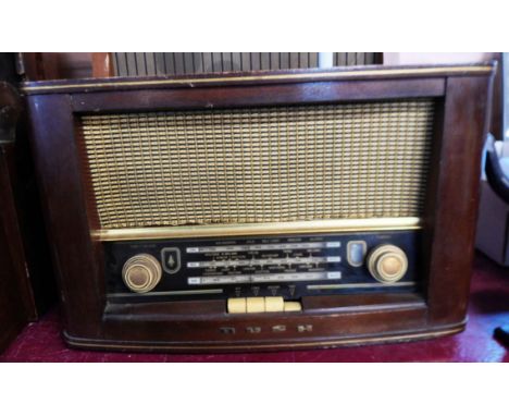 Three vintage wooden cased valve radios comprising a Bush Type VHF72, a Murphy Type A212 and a Pye Cambridge with magic eye