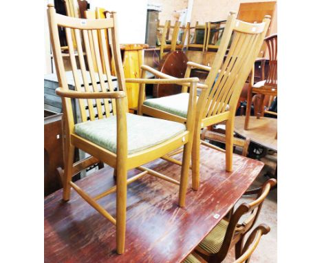 A pair of modern Ercol light elm elbow chairs with high slat backs and swab cushions, set on moulded square legs - inset meta