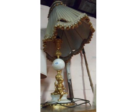 An early 20th Century ormulu and marble table lamp with Rococo and acanthus leaf column and a putto with a trident to base