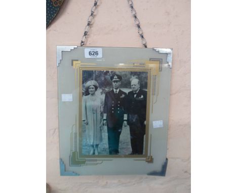 An Art Deco photographic clip frame with stencilled geometric block mount and aluminium corner clips, containing a photograph