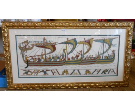 A large ornate gilt framed reproduction embroidery panel after part of The Bayeux Tapestry - 48cm X 1.08m