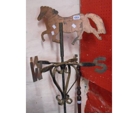 An old wrought iron and copper weathervane with horse finial