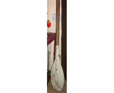 A large vintage wooden double ended kayak paddle