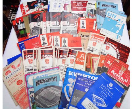 A collection of assorted vintage football programmes including Arsenal, Man City, Everton, West Ham and Manchester United, et