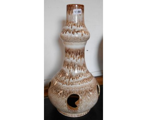 A large Mid Century ceramic table lamp base of tall bottle form with reticulated bulbous base, covered in a streaky Fat Lava 