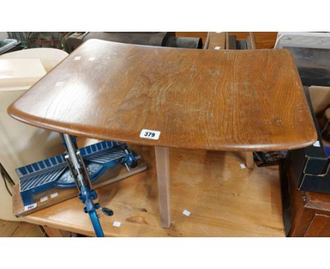 An Ercol light elm tea table with solid sectional top, set on chamfered square supports