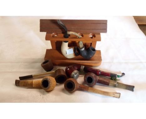 A bag containing a quantity of vintage pipes including meerschaum, briar, etc. - sold with a wooden pipe rack