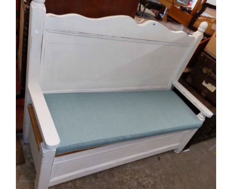 A 1.4m white painted pine locker bench with shaped and panelled back, flanking open armrest and squat bun feet