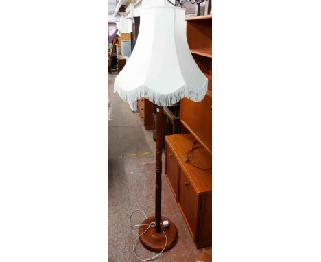 A vintage mahogany standard lamp with ring turned pillar and circular base - with shade