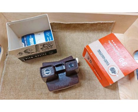 A vintage Bakelite Viewmaster 3D viewer in original box with assorted slide reels