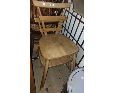 A pair of Mid-Century Ercol light elm 'green spot' stacking chairs with solid sectional seats, set on slender tapered support