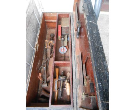 An old shipwright's chest with fitted interior and brass plaque to top E.V. Grant, containing a quantity of assorted tools in
