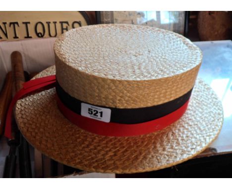 A vintage Christy's of London straw boater with black and red ribbon decoration