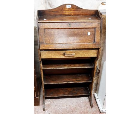 A 54cm early 20th Century stained oak student's bureau with part fitted interior, drawer and open shelves under, set on shape