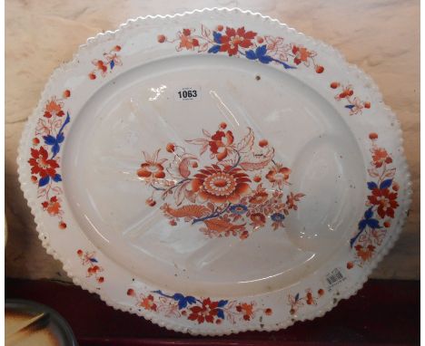 A large Chamberlains Worcester meat platter with moulded gravy well, decorated in iron red and cobalt blue with central flora