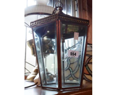 A vintage copper hanging hall lamp with bevelled glass panels