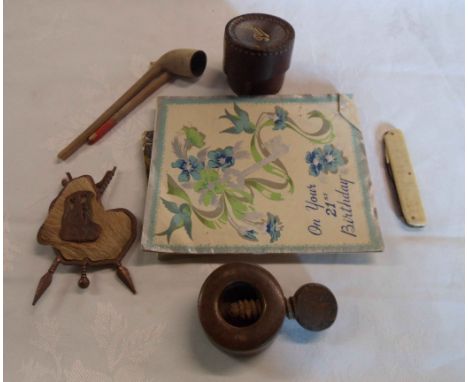 A bag containing a quantity of assorted collectable items including clay pipe, wooden nutcracker, leather stud box, etc.