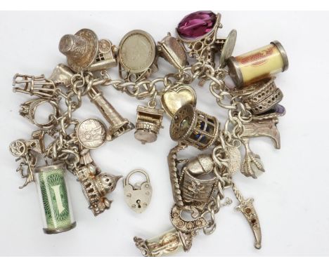 Silver charm bracelet with hallmarked silver padlock clasp and thirty two charms, padlock present but detached, L: 18 cm, 103