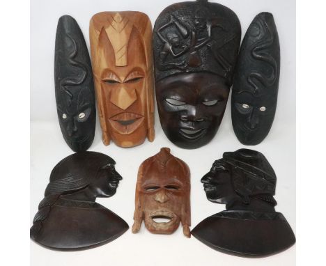 Seven wooden Tribal art wall masks, largest H: 37 cm. UK P&amp;P Group 3 (£30+VAT for the first lot and £8+VAT for subsequent