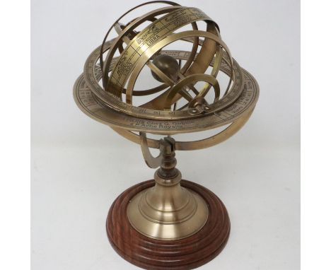 Brass armillary displaying signs of the zodiac raised on a turned wood socle. H: 28cm.  UK P&amp;P Group 2 (£20+VAT for the f