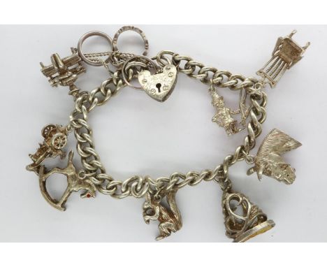 Hallmarked silver charm bracelet with padlock clasp, safety chain and nine charms, L: 18 cm, 49g. UK P&amp;P Group 1 (£16+VAT