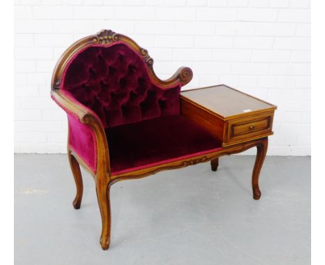 A mahogany framed telephone seat, the shell carved top rail over an upholstered button back and seat, raised on cabriole supp