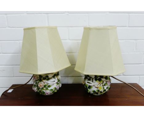 A pair of continental porcelain floral encrusted porcelain table lamp bases, complete with shades, approx 17cm high, excludin