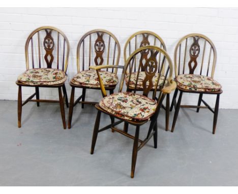 Five Ercol dark elm Windsor style chairs to include one carver, all with fleur de lys motif , 82 x 64cm (5)