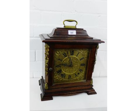 A mahogany cased bracket clock, brass dial with foliate spandrels and Roman numerals on bracket supports, 30 x 38cm high