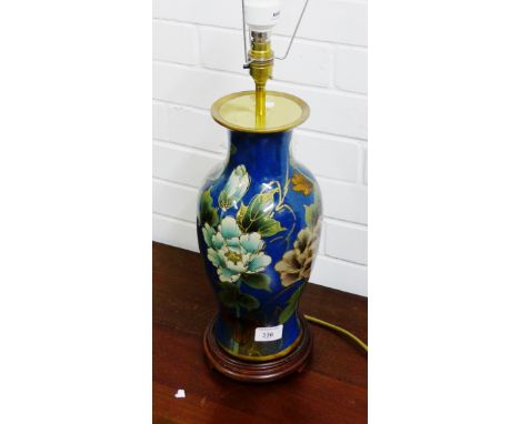 A floral patterned table lamp base and shade 