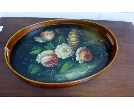 An oval wooden tray painted in oil with a floral pattern to centre, 48 x 32cm