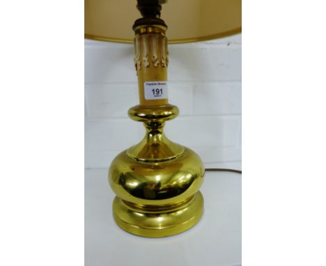 A faux brass table lamp and shade