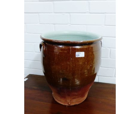 A brown glazed terracotta planter, 38cm high