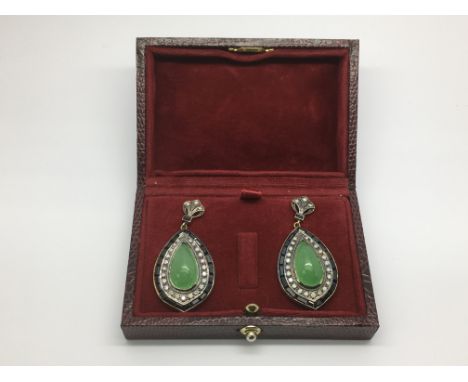 A boxed pair of gold and silver drop earrings set with jade, onyx and diamonds.