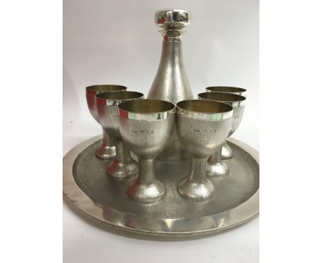 A  House of Lawrian silver decanter set comprising a circular tray six cupsAnd decanter London hallmarks 1975 , 2.659 kilo ap