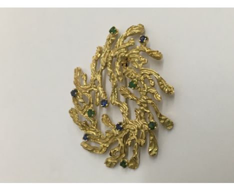 A 18 k gold contemporary brooch inset with emeralds and sapphires Total weight 17 grams.