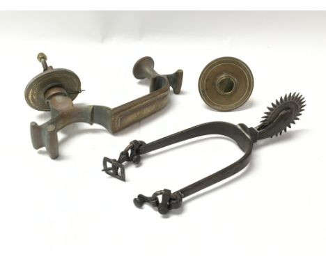 A vintage brass door knocker and a vintage cow boy style horse spur